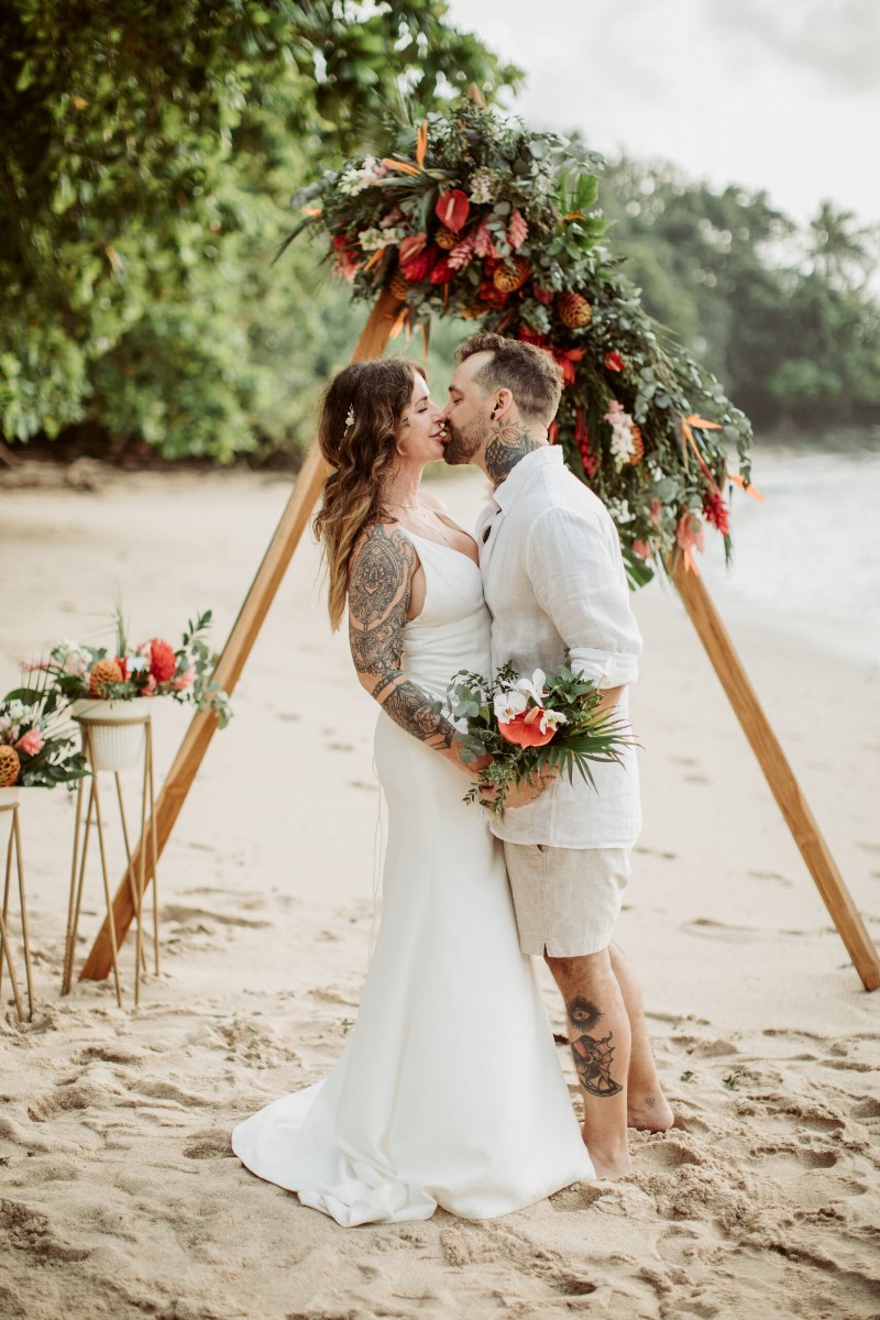 romantic beach wedding kiss